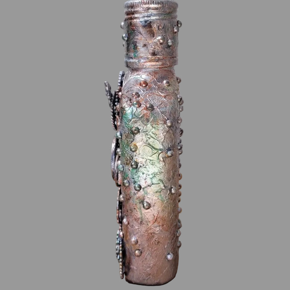 small upcycled bottle hand decorated in steampunk genre