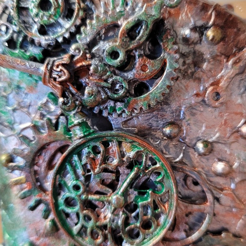 small upcycled bottle hand decorated in steampunk genre