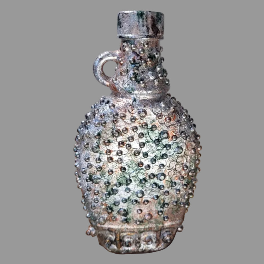 Small upcycled bottle, with handle decorated in steampunk